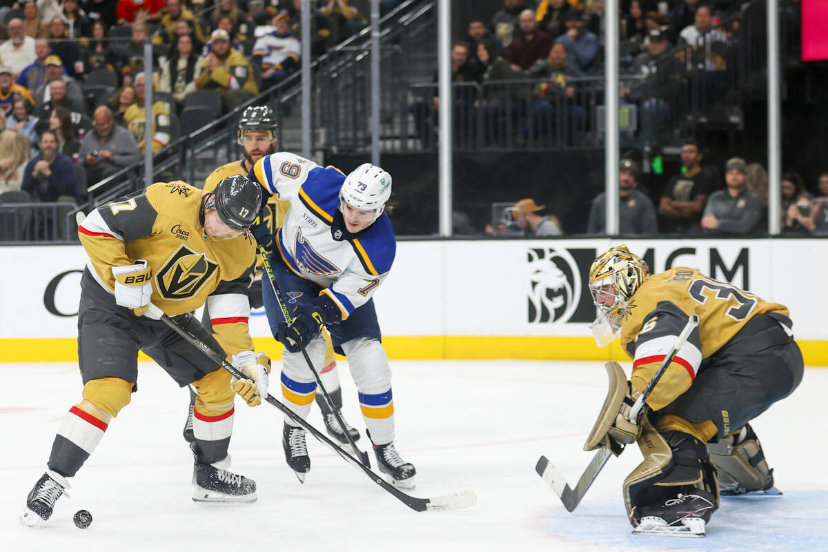 Vegas Golden Knights defenseman Ben Hutton (17) attempts to clear the puck past St. Louis Blues ...