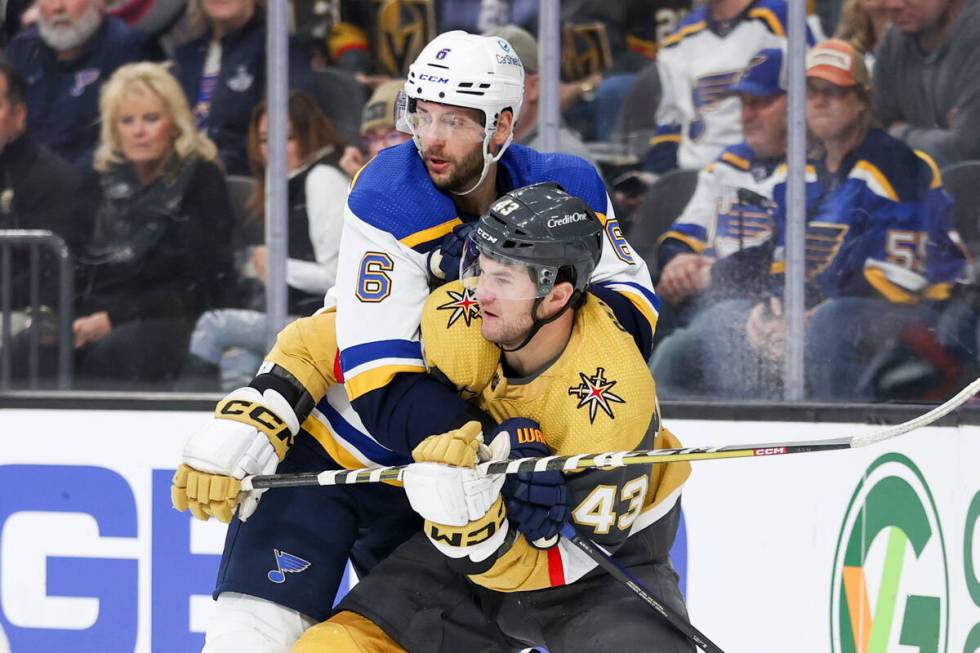 St. Louis Blues defenseman Marco Scandella (6) grabs Vegas Golden Knights center Paul Cotter (4 ...