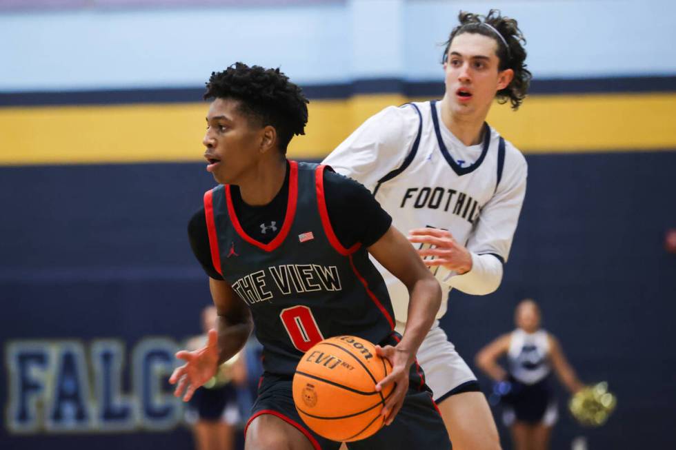 Arbor View’s DeMarion Yap (0) dribbles past Foothill’s Zak Abdalla (11) during a ...