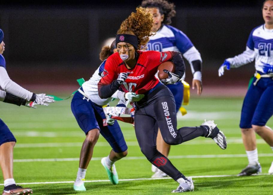 Desert Oasis defender Brooklin Hill (10) runs past Shadow Ridge defender Kyliah Rivera-Kyle (1) ...