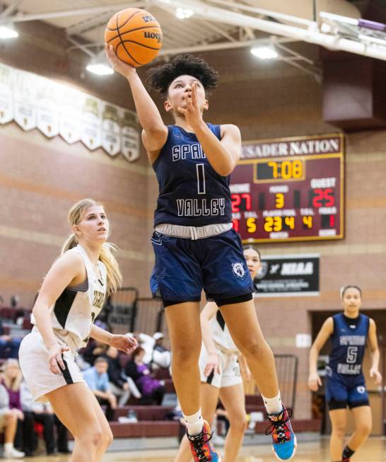 Spring Valley's high Mia Ervin (1) shoots for the basket as Faith Lutheran's Raina Forgue (23) ...