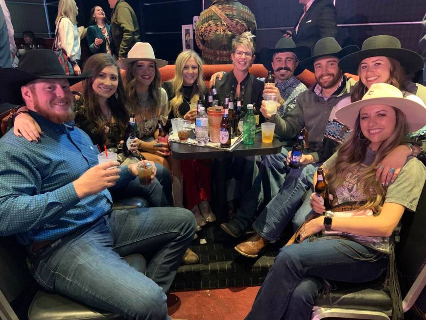 A group of rodeo party-goers soaks in the vibe at the South Point Showroom's viewing party/go-r ...