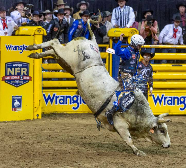 Stetson Wright of Milford, Utah, rides Pookie Holler to a winning score in Bull Riding during t ...