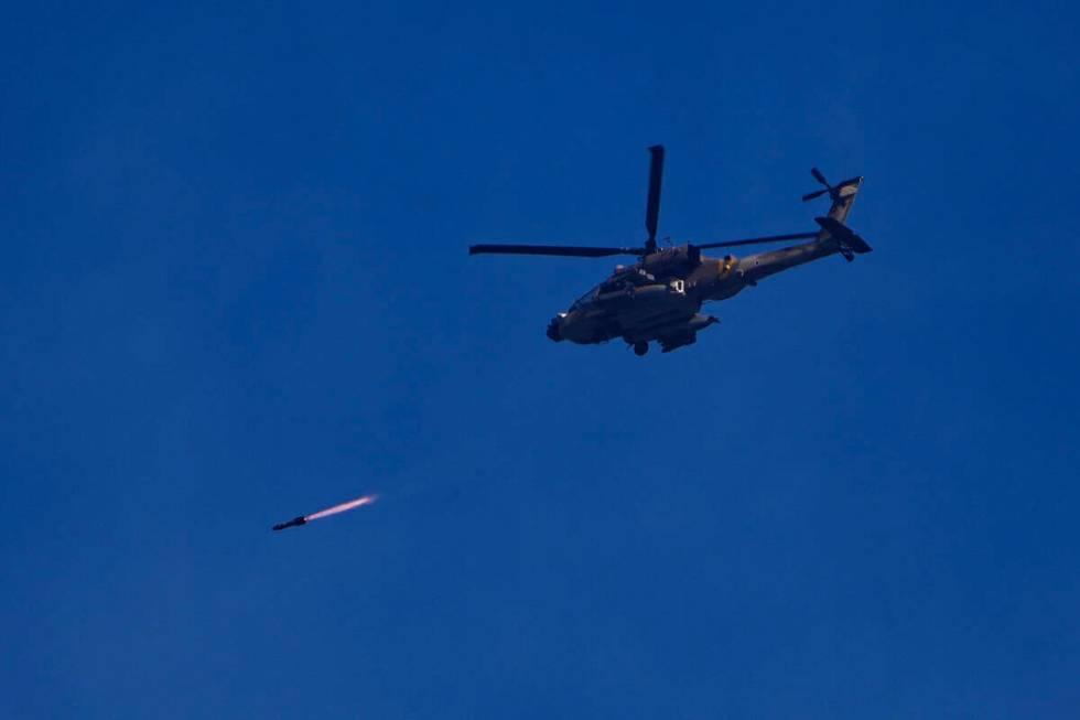 An Israeli Apache helicopter fires a missile in direction of the Gaza Strip, as seen from south ...