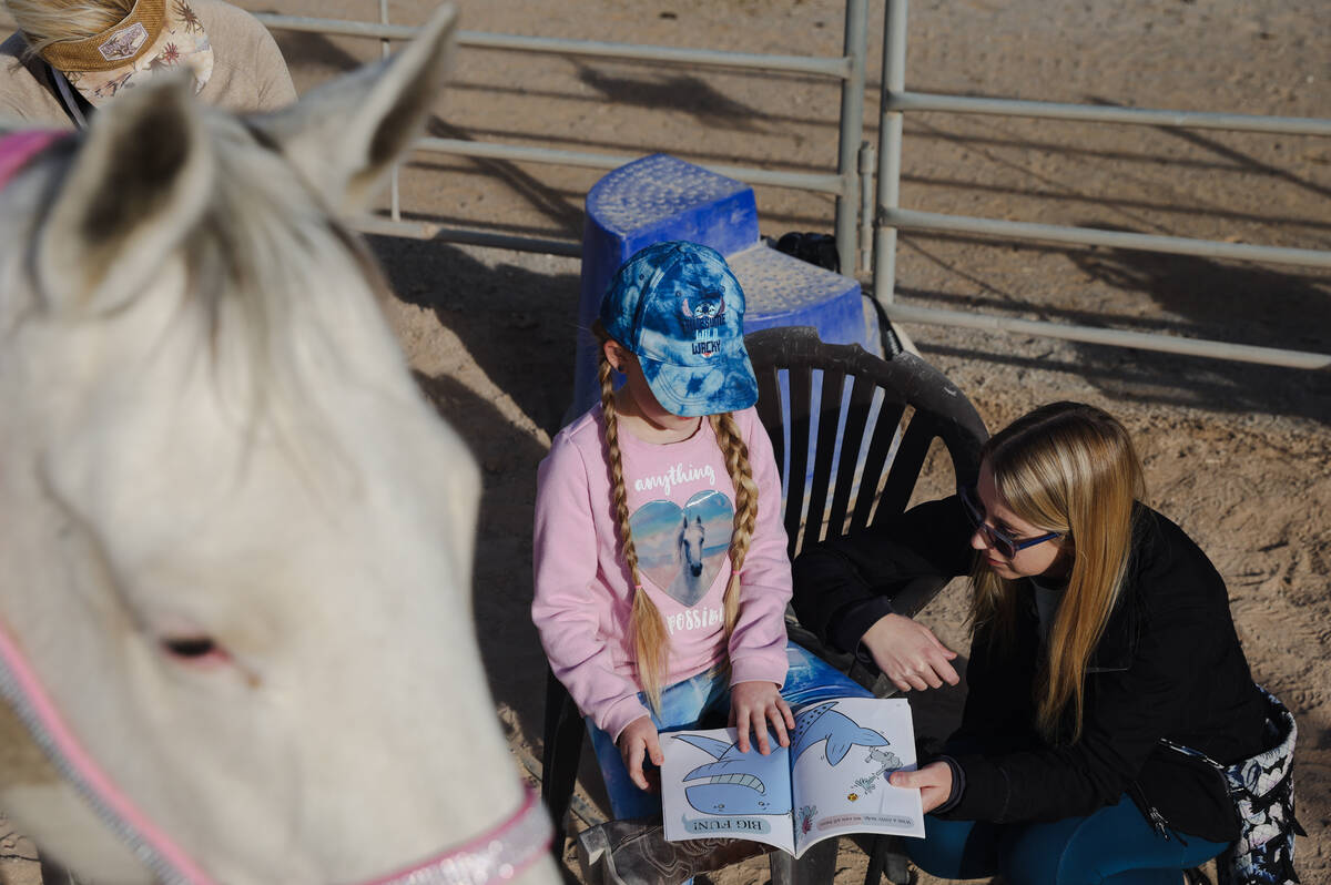 Eliora Oles, 9, reads to Lagertha with help from her mom Kelly Oles at Talisman Farm in Las Veg ...