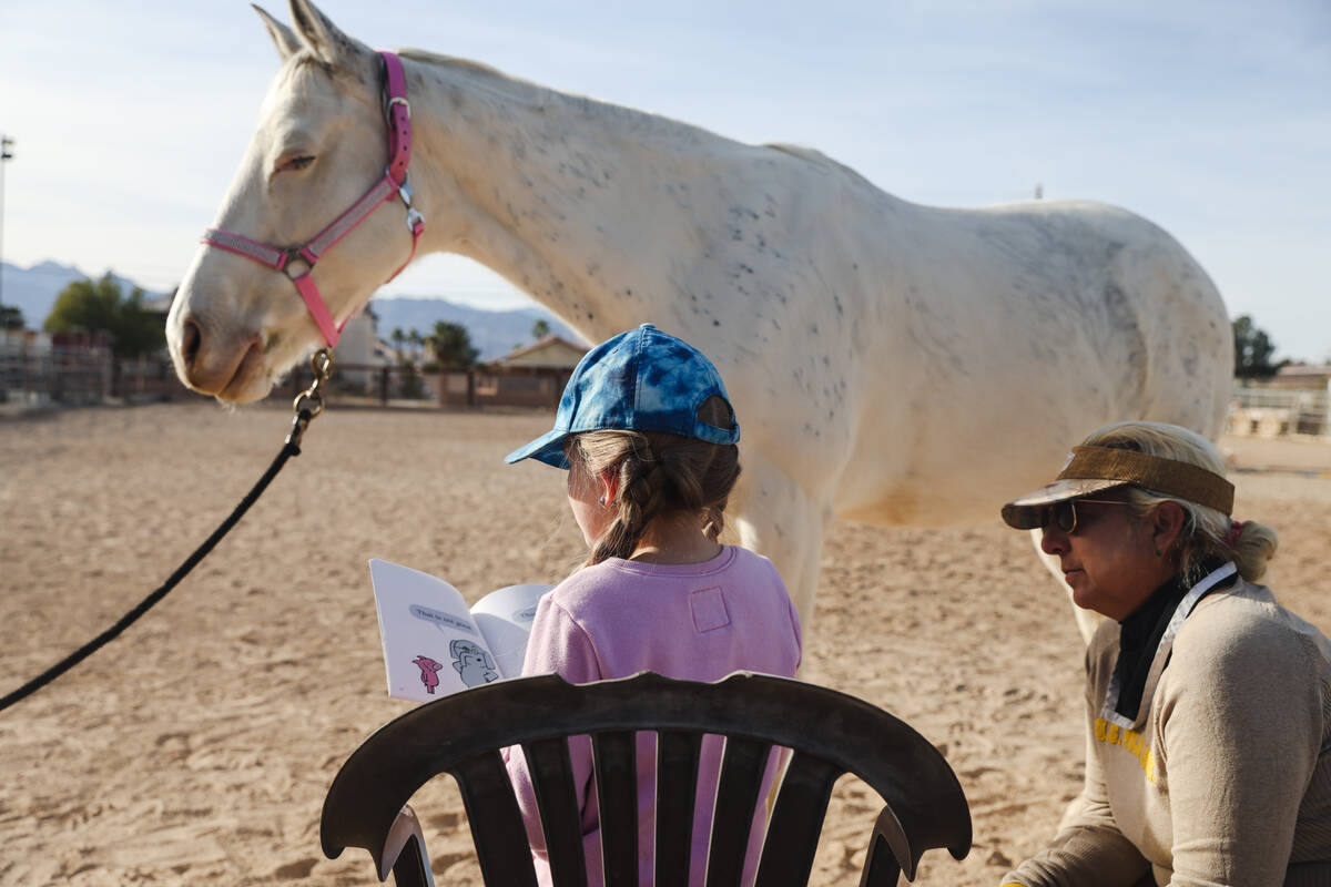 Eliora Oles, 9, reads to Lagertha as Esther Hillner looks on at Talisman Farm in Las Vegas, Sun ...