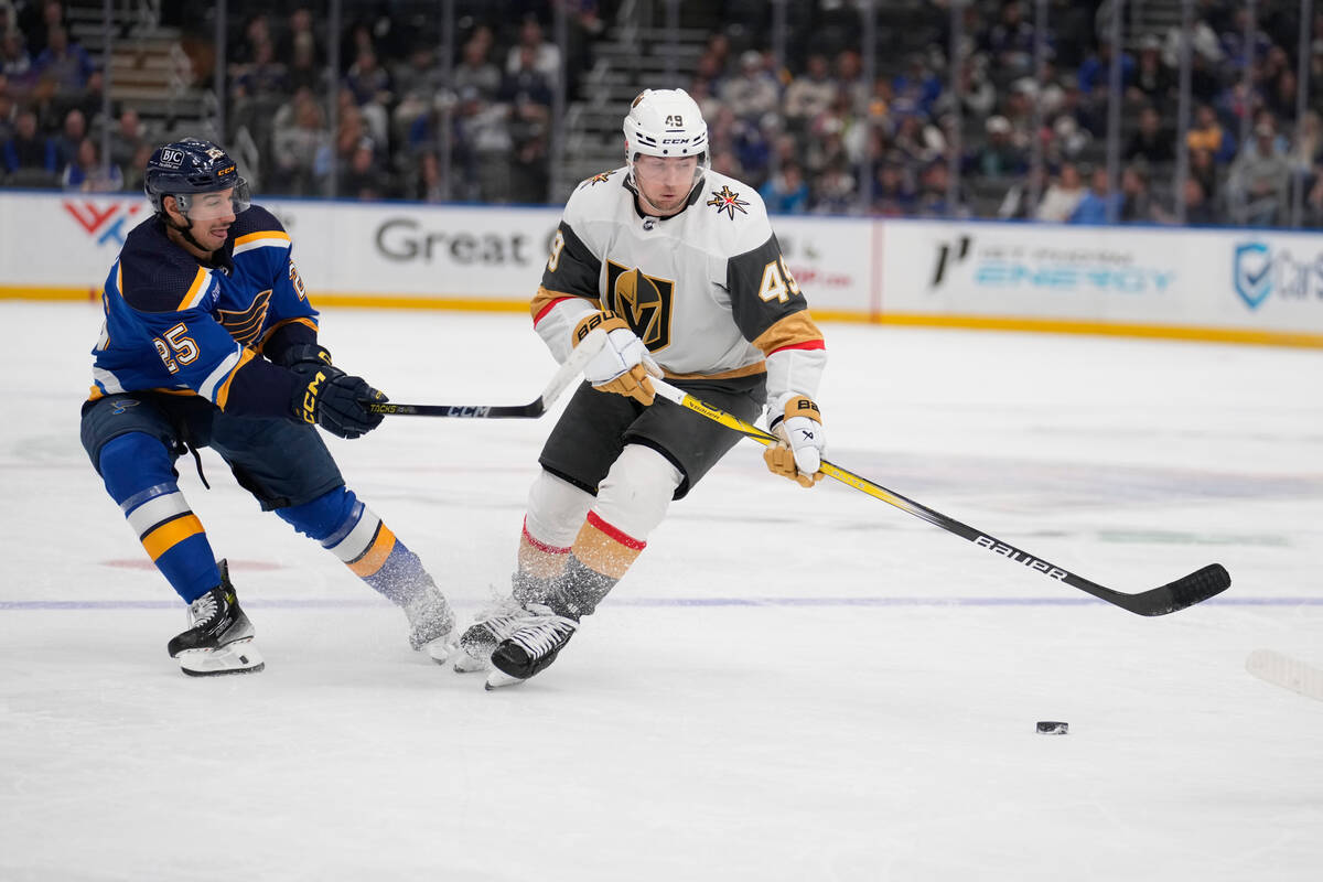 St. Louis Blues' Jordan Kyrou (25) and Vegas Golden Knights' Ivan Barbashev (49) battle for a l ...