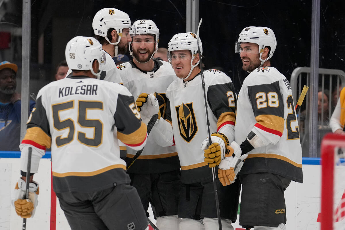 Vegas Golden Knights' Zach Whitecloud (2) is congratulated by teammates after scoring during th ...