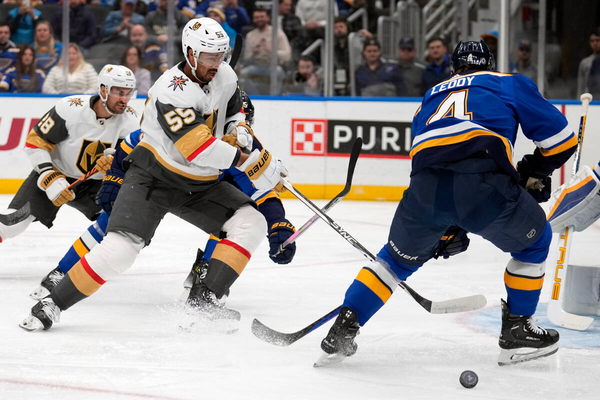 Vegas Golden Knights' Keegan Kolesar (55) reaches for a loose puck as St. Louis Blues' Nick Led ...