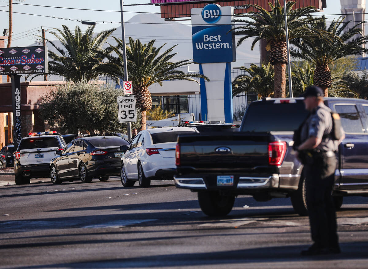 Police gather outside the Best Western on Paradise Road in Las Vegas, Wednesday, Dec. 6, 2023. ...