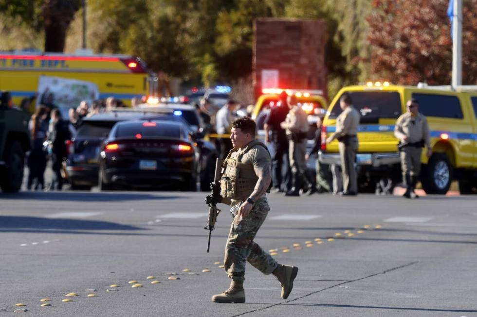 Police evacuate students on Harmon Avenue near Maryland Parkway after a shooing on the UNLV cam ...