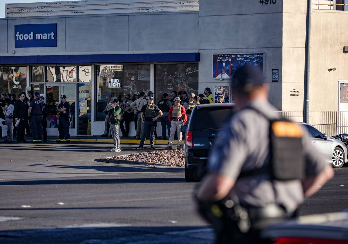 Police gather outside the Best Western on Paradise Road in Las Vegas, Wednesday, Dec. 6, 2023. ...