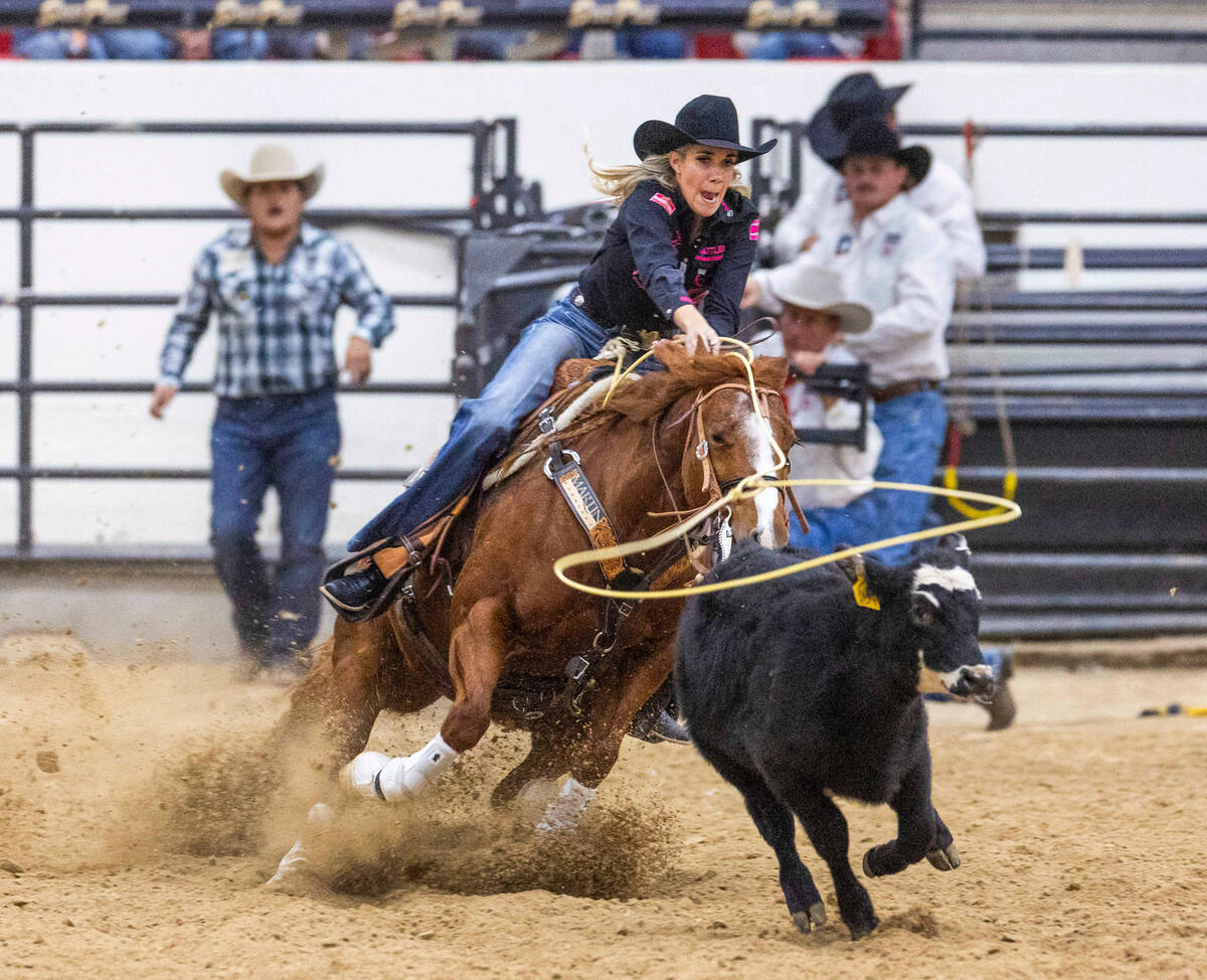 Sarah Angelone of Stephenville, Texas, ropes a calf during the NFR breakaway roping challenge a ...