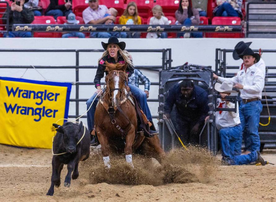 Sarah Angelone of Stephenville, Texas, ropes a calf in record time during the NFR breakaway rop ...
