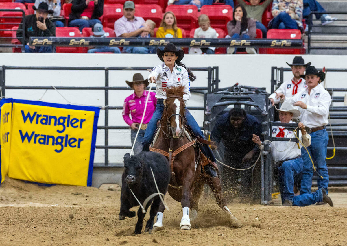 Shelby Boisjoli-Meged of Stephenville, Texas, ropes a calf during the NFR breakaway roping chal ...