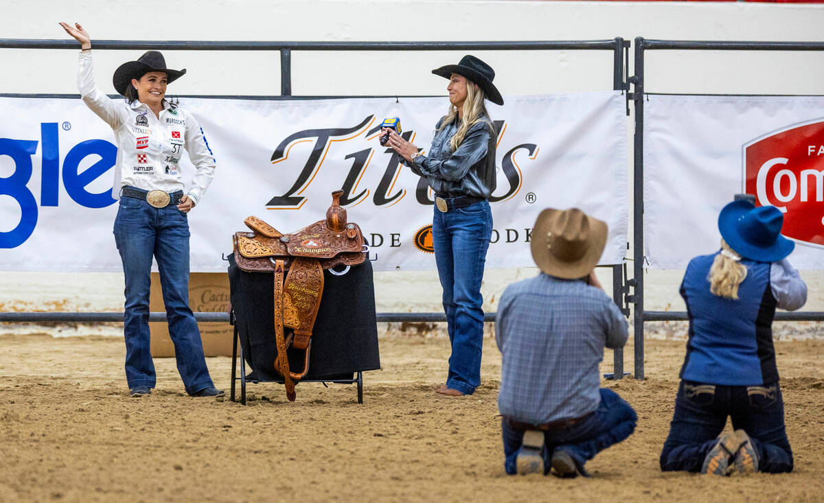 Shelby Boisjoli-Meged of Stephenville, Texas, waves to the crowd while receiving her saddle as ...