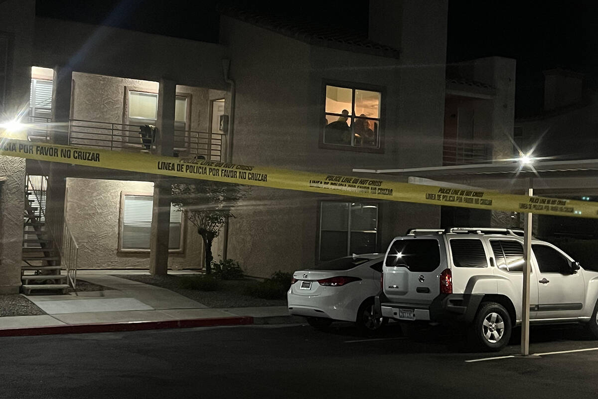 Law enforcement officers search an apartment at 360 North Arroyo Grande Parkway in Henderson on ...