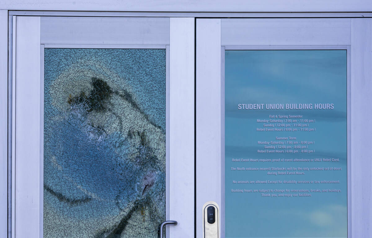 A front door glass panel is shattered at the Student Union following the shooting yesterday on ...