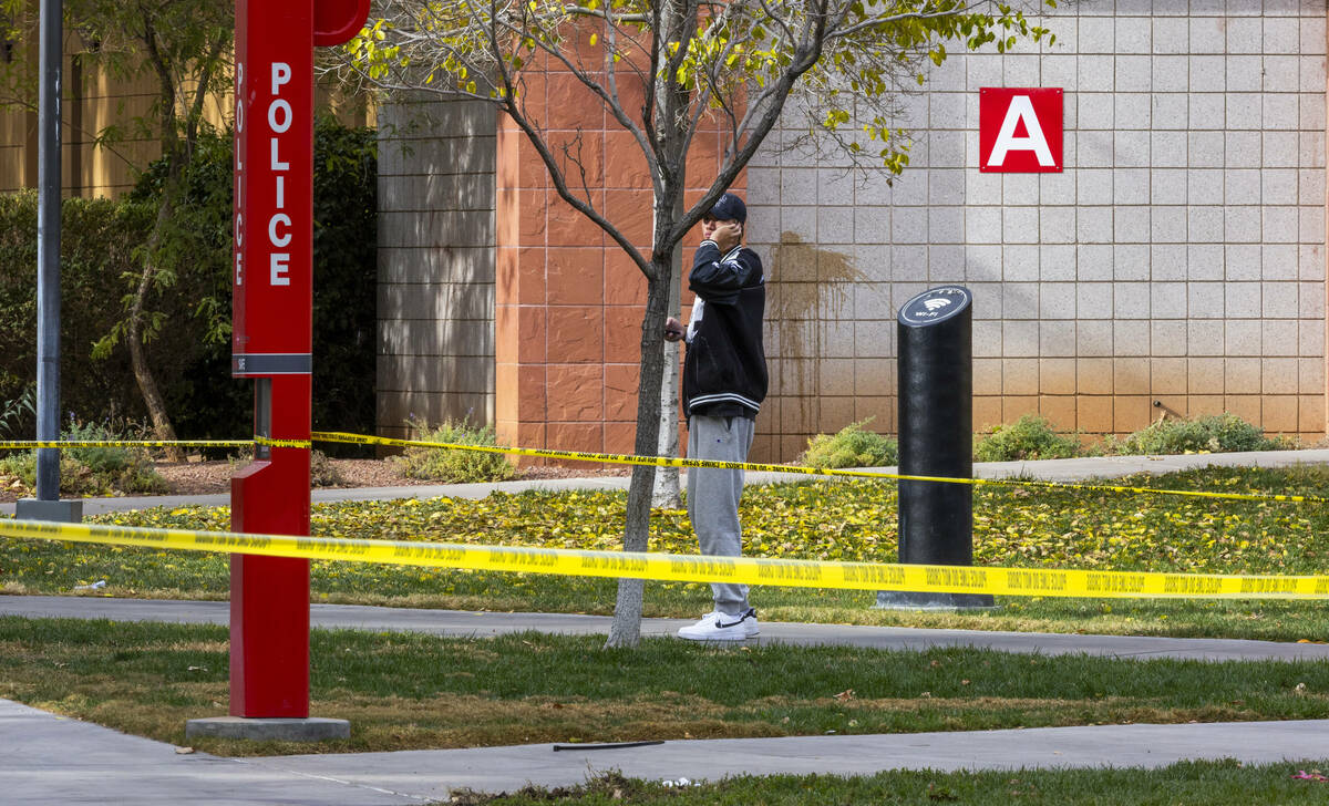 A student stands outside the entrance to the Frank and Estella Beam Hall following the shooting ...