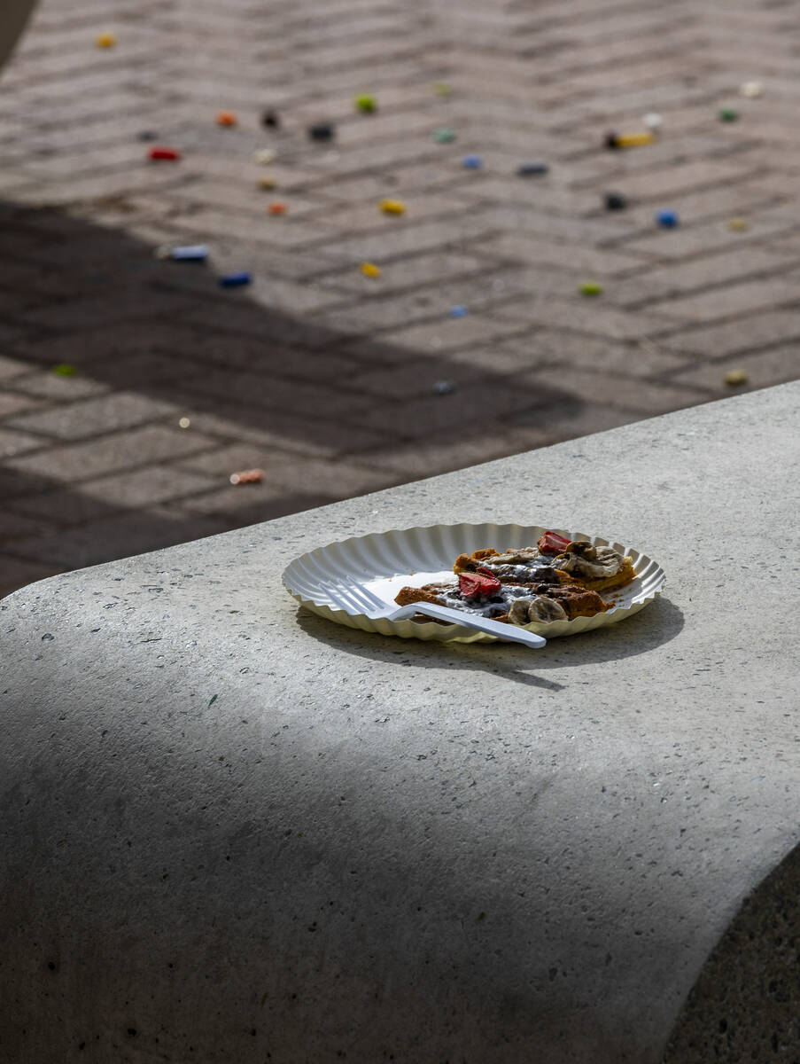 A plate of food and Legos remain scattered on the ground outside the Student Union from an even ...