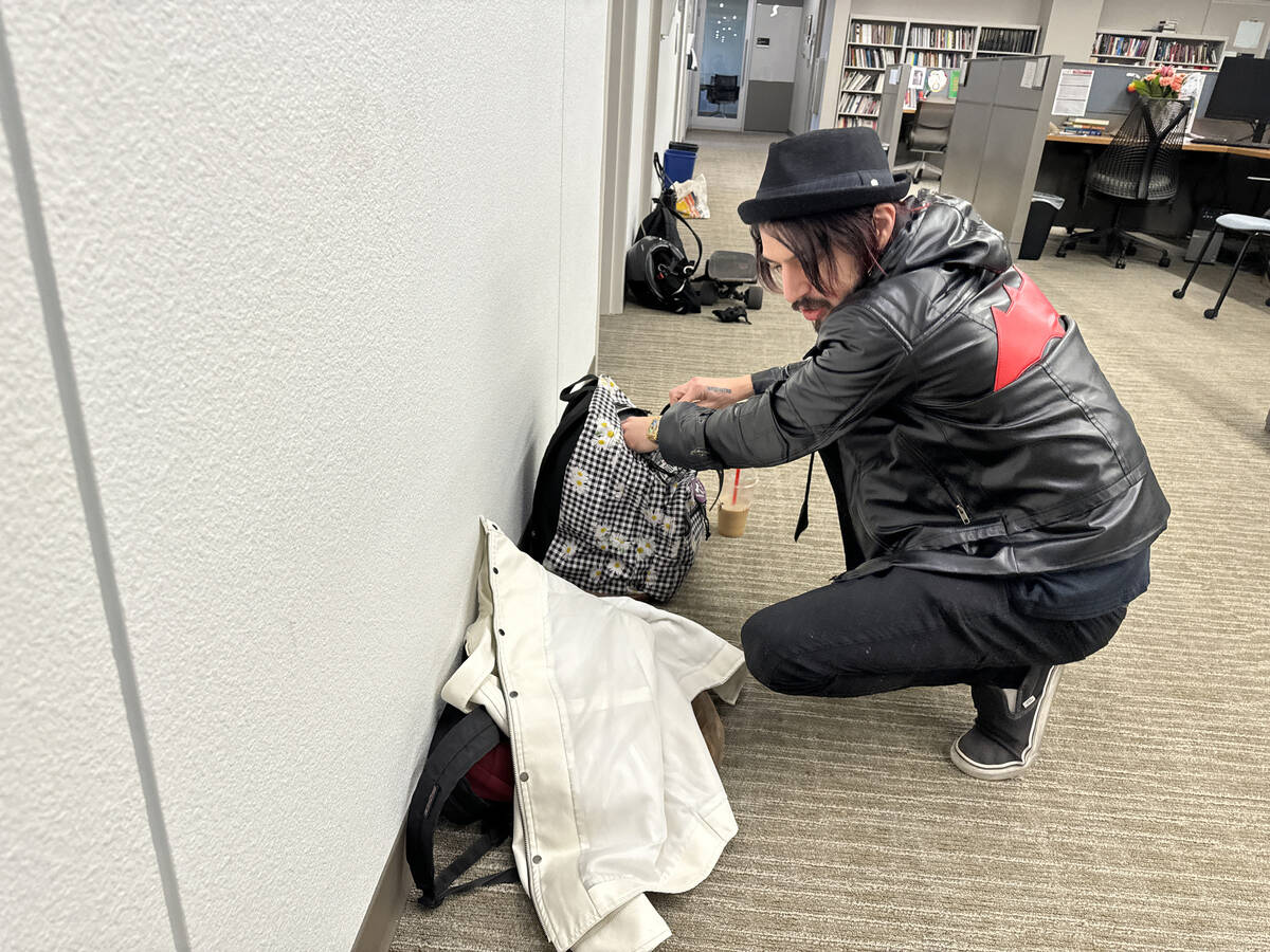 Staff member Gregory Galindo retrieves backpacks and personal items left behind by friends on t ...