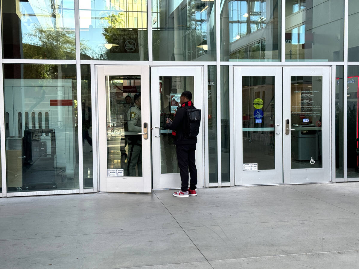 A student tries to retrieve personal items in the Student Union on the UNLV campus in Las Vegas ...