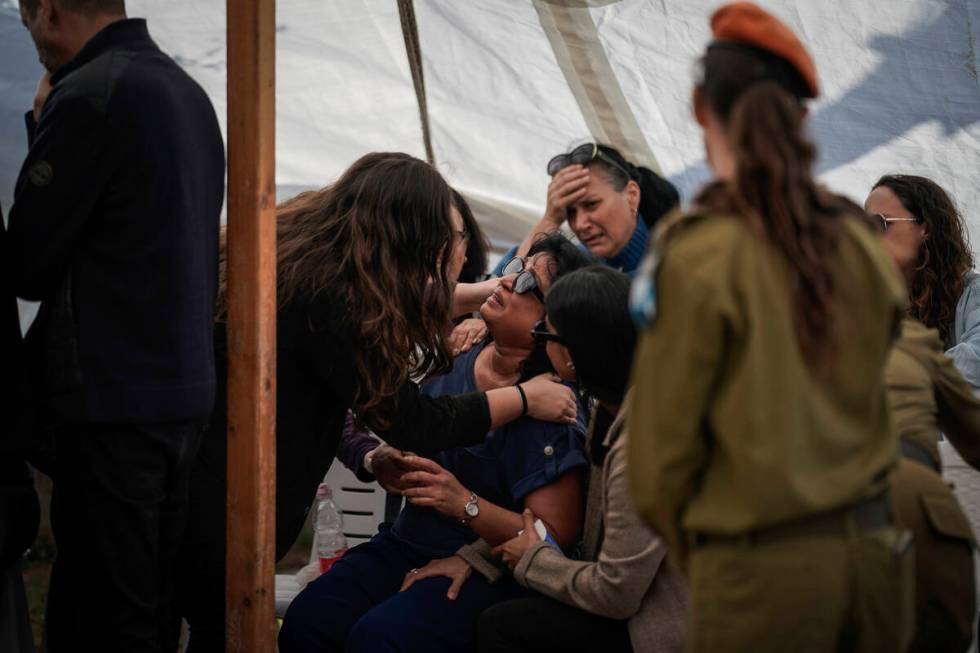 Mourners comfort Mazal Daniels, center, the mother of Israeli reservist Master Sgt. Gil Daniels ...