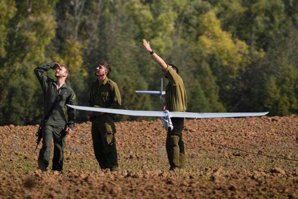 Israeli soldiers operate a drone near the Israeli-Gaza border, southern Israel, Wednesday, Dec. ...