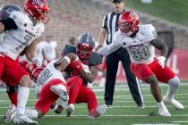 New Mexico's Jacory Croskey-Merritt (5) carries the ball close to a first down before being br ...