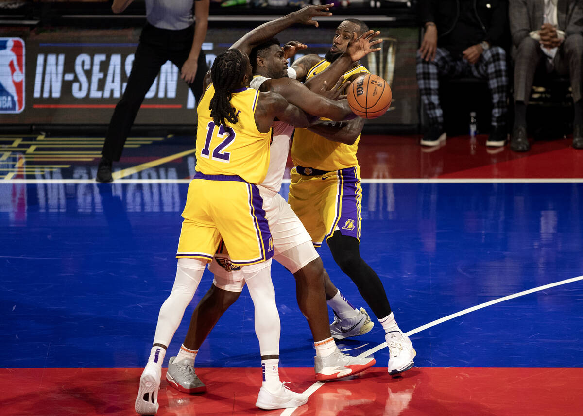 New Orleans Pelicans forward Zion Williamson (1) is surrounded by Los Angeles Lakers forward Ta ...