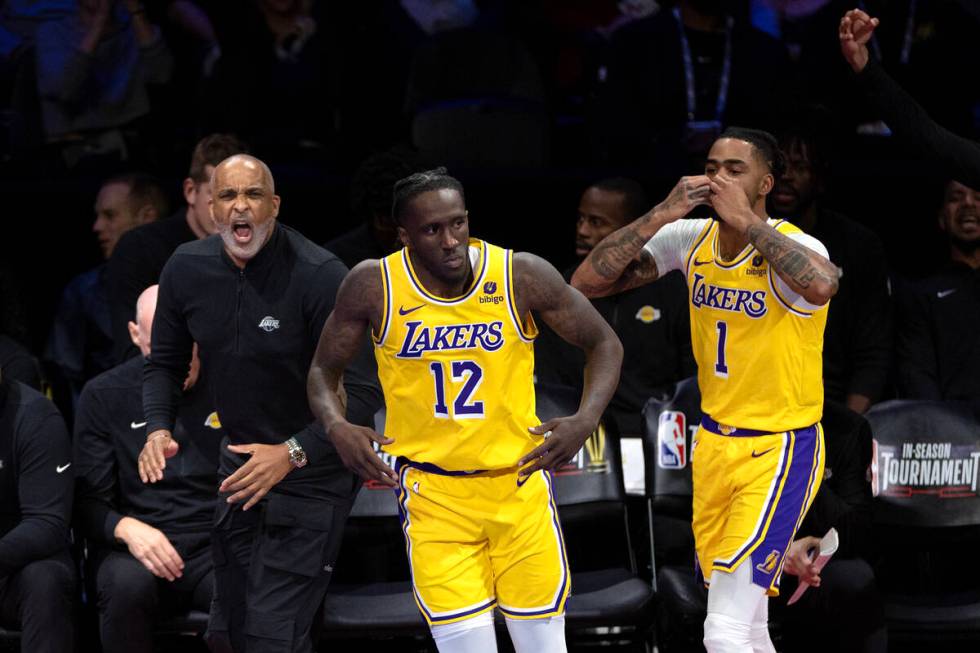 Los Angeles Lakers guard D'Angelo Russell (1) celebrates after scoring alongside head coach Dar ...