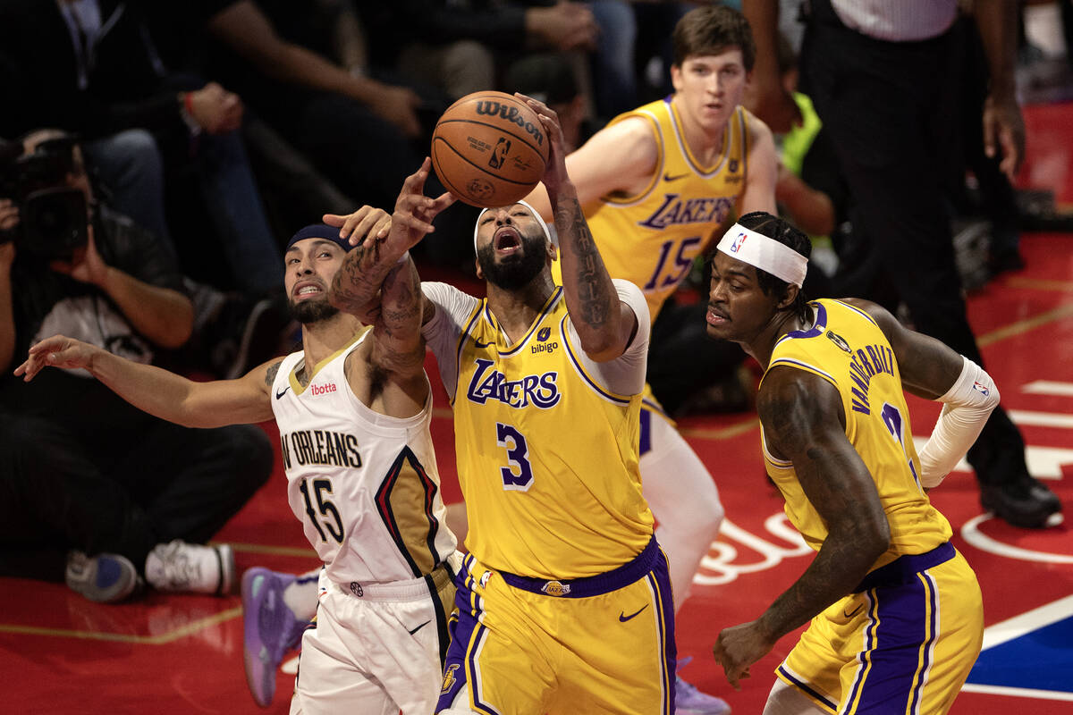 Los Angeles Lakers forward Anthony Davis (3) and New Orleans Pelicans guard Jose Alvarado (15) ...