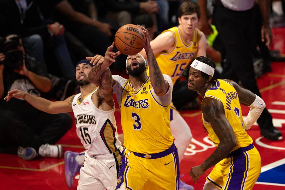 Los Angeles Lakers forward Anthony Davis (3) and New Orleans Pelicans guard Jose Alvarado (15) ...