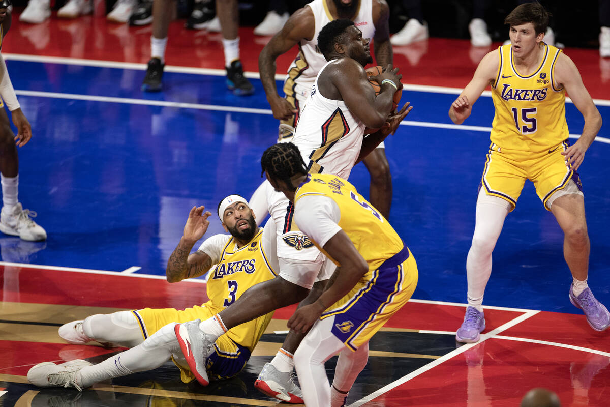 New Orleans Pelicans forward Zion Williamson (1) drags through defense by Los Angeles Lakers fo ...