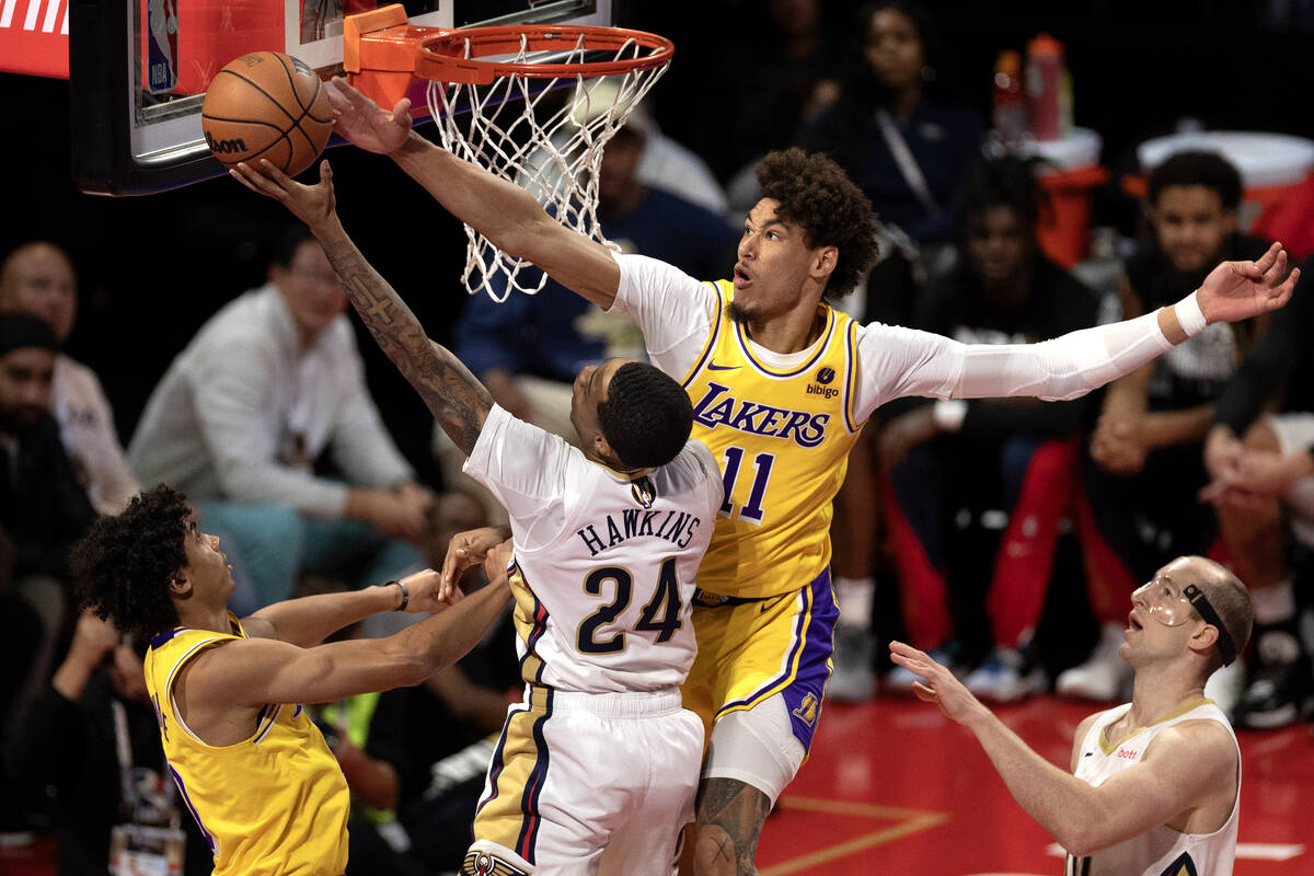 New Orleans Pelicans guard Jordan Hawkins (24) shoots against Los Angeles Lakers center Jaxson ...