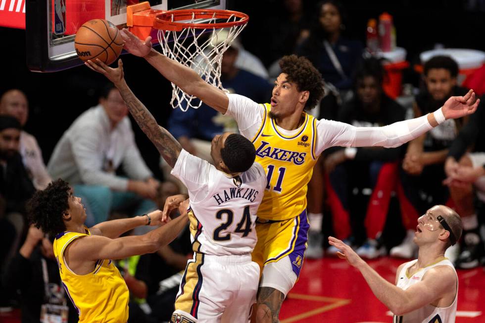 New Orleans Pelicans guard Jordan Hawkins (24) shoots against Los Angeles Lakers center Jaxson ...