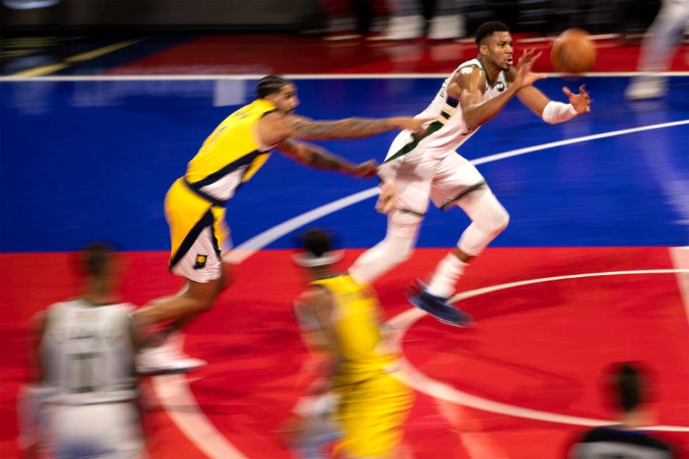 Milwaukee Bucks forward Giannis Antetokounmpo (34) receives a pass with pressure from Indiana P ...