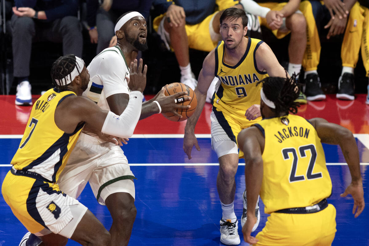 Milwaukee Bucks forward Bobby Portis (9) shoots while surrounded by Indiana Pacers guard Buddy ...