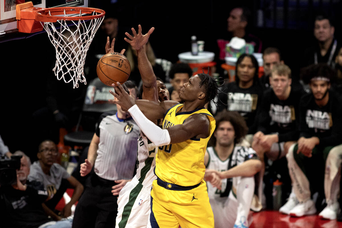 Indiana Pacers guard Bennedict Mathurin (00) shoots against Milwaukee Bucks forward Giannis Ant ...