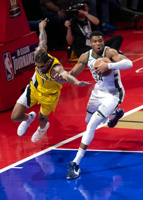 Milwaukee Bucks forward Giannis Antetokounmpo (34) works the ball against Indiana Pacers forwar ...