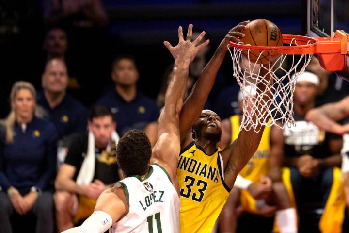 Indiana Pacers center Myles Turner (33) dunks against Milwaukee Bucks center Brook Lopez (11) d ...