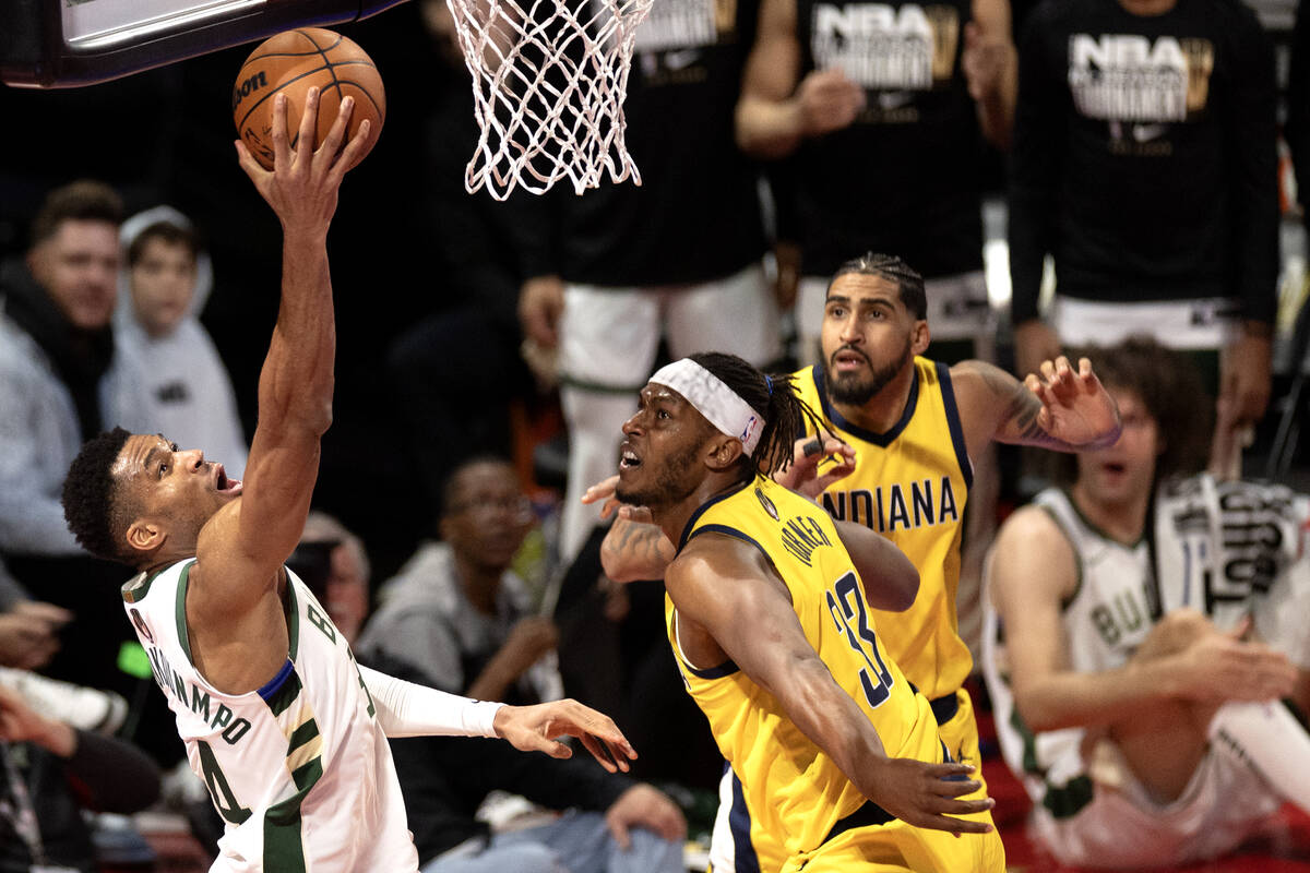 Milwaukee Bucks forward Giannis Antetokounmpo (34) shoots against Indiana Pacers center Myles T ...