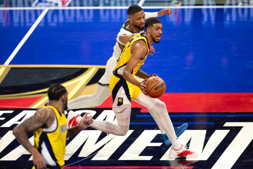 Indiana Pacers guard Tyrese Haliburton (0) dribbles against Milwaukee Bucks guard Damian Lillar ...