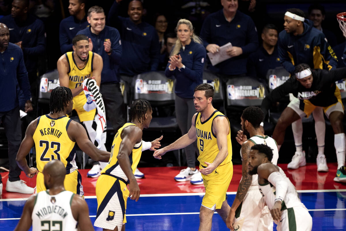 Indiana Pacers guard T.J. McConnell (9) celebrates with guard Bennedict Mathurin (00) after reg ...