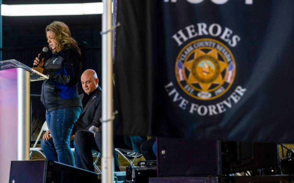 Christa Swanger, widow of Officer Jason Swanger, gives an opening prayer during a candlelight v ...