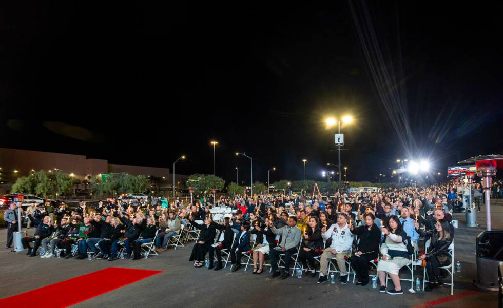 Family and supporters hold up lighted candles during a candlelight vigil for Nevada Highway Pat ...