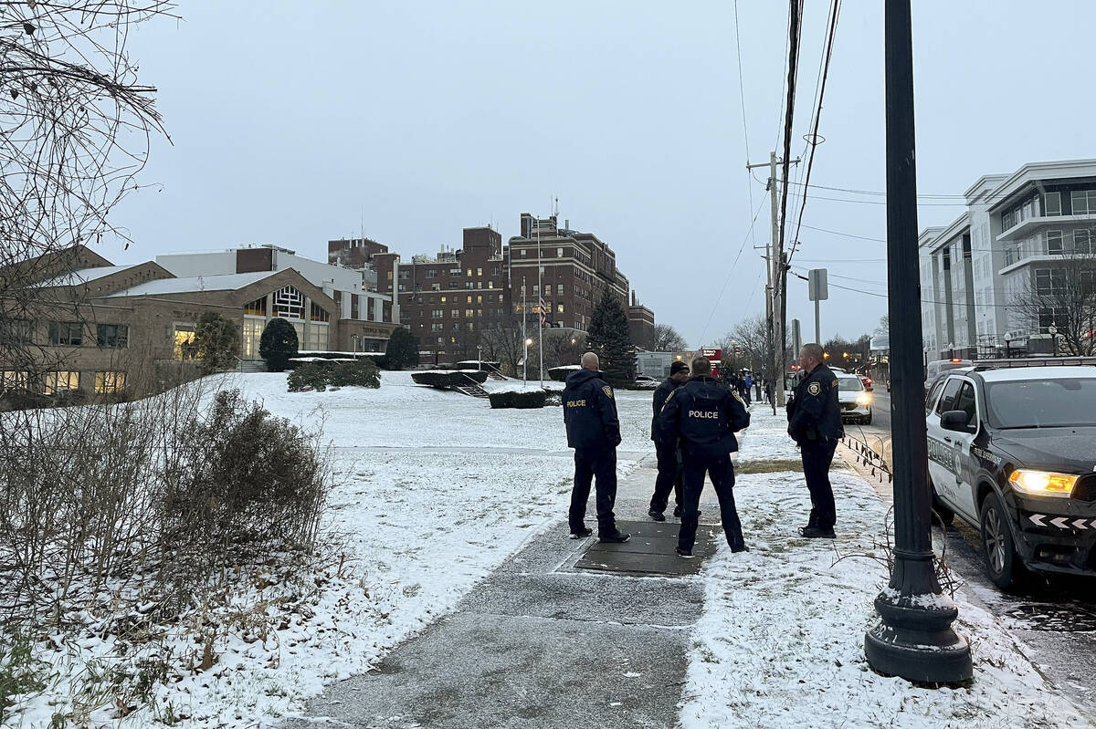 Albany police officers gather outside Temple Israel, Thursday, Dec. 7, 2023, in Albany, N.Y. A ...