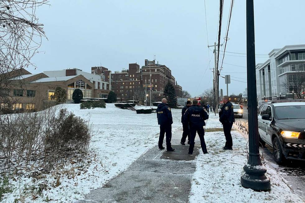 Albany police officers gather outside Temple Israel, Thursday, Dec. 7, 2023, in Albany, N.Y. A ...