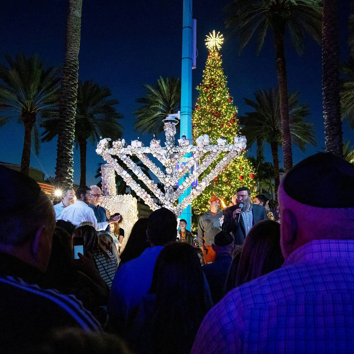 The community congregated to light artist Roger Abramsonís unique seashell covered menorah ...