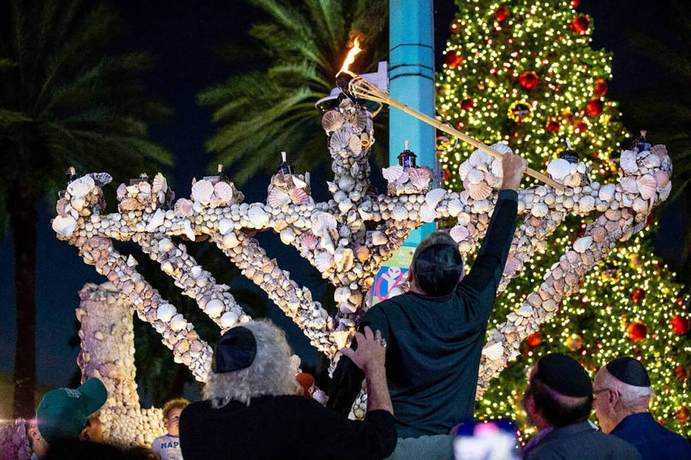 The community gathered to light artist Roger Abramson's unique seashell covered menorah in 2021 ...